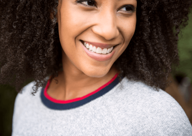 girl holding Invisalign Clear Aligners